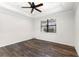 Bedroom with crown molding, ceiling fan, wood floors and large window at 19023 Mangieri St, Venice, FL 34293