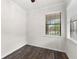 Bright bedroom with a ceiling fan, window, and dark-stained wood floors at 19023 Mangieri St, Venice, FL 34293