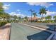 Community bocce ball court with a clubhouse and palm trees offering recreational opportunities for residents at 19023 Mangieri St, Venice, FL 34293