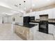Bright kitchen featuring granite countertops, white cabinets, stainless steel appliances, pendant lighting and brick accents at 19023 Mangieri St, Venice, FL 34293