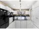 Bright kitchen features an island with granite countertops, white cabinetry, stainless appliances, and a brick backsplash at 19023 Mangieri St, Venice, FL 34293