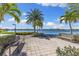 Tranquil view of the lake with benches, lush landscaping, and palm trees, perfect for relaxing and enjoying the scenery at 19023 Mangieri St, Venice, FL 34293