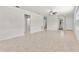 Bright living room featuring neutral tile flooring and a ceiling fan at 19023 Mangieri St, Venice, FL 34293