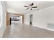Spacious living room with an open flow to the kitchen and neutral flooring at 19023 Mangieri St, Venice, FL 34293