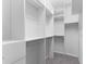 Bright walk-in closet with shelving and metal hanging rods providing ample storage space at 19023 Mangieri St, Venice, FL 34293
