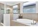 Luxurious bathroom featuring a separate shower and soaking tub at 201 Vinadio Blvd, Nokomis, FL 34275