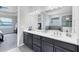 Modern bathroom with double sinks, sleek vanity, and neutral tones at 201 Vinadio Blvd, Nokomis, FL 34275