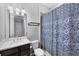 Bathroom with modern fixtures, tile floor, and decorative shower curtain at 201 Vinadio Blvd, Nokomis, FL 34275
