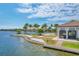 Community lake with a wooden dock, beach area, and building with lush landscaping at 201 Vinadio Blvd, Nokomis, FL 34275