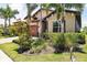Beautifully landscaped home exterior with lush tropical plants and well-maintained lawn at 201 Vinadio Blvd, Nokomis, FL 34275