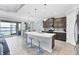 Modern kitchen with a large island, pendant lighting, stainless steel appliances, and dining area at 201 Vinadio Blvd, Nokomis, FL 34275