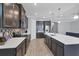 Modern kitchen with a large island, stainless steel appliances, and tile backsplash at 201 Vinadio Blvd, Nokomis, FL 34275