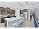 Well-appointed kitchen with quartz island, stainless steel appliances, pendant lighting and tile backsplash at 201 Vinadio Blvd, Nokomis, FL 34275