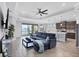 Spacious living room with tile floors, fan, recessed lighting and view of pond at 201 Vinadio Blvd, Nokomis, FL 34275