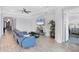 Bright living room with tile floors, fan, and a comfortable blue sofa at 201 Vinadio Blvd, Nokomis, FL 34275