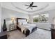Spacious main bedroom with tray ceiling and view of the lake at 201 Vinadio Blvd, Nokomis, FL 34275