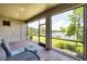 This patio features brick flooring, a view of the lake, outdoor furniture, and a screened-in enclosure at 201 Vinadio Blvd, Nokomis, FL 34275