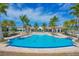 Large community pool with blue water and palm trees around the pool and clubhouse at 201 Vinadio Blvd, Nokomis, FL 34275