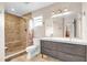 Well-lit bathroom featuring a modern double sink vanity and a large walk-in shower at 2218 Woodmere Rd, Venice, FL 34293