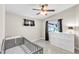 Bedroom featuring a ceiling fan, a neutral color palette, and a changing table at 2218 Woodmere Rd, Venice, FL 34293