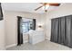 Well-lit bedroom with a ceiling fan, a dresser, and neutral paint at 2218 Woodmere Rd, Venice, FL 34293