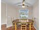 Cozy dining area featuring an oval wooden table and four chairs, illuminated by a window at 2218 Woodmere Rd, Venice, FL 34293