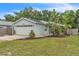 Charming single-story home featuring a two-car garage, well-maintained lawn, and mature landscaping at 2218 Woodmere Rd, Venice, FL 34293