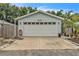 Exterior view of a one-car garage with an attached storage room and front parking at 2218 Woodmere Rd, Venice, FL 34293