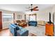 Inviting living room featuring hardwood floors, a ceiling fan, and stylish blue couches at 2218 Woodmere Rd, Venice, FL 34293