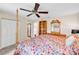 Comfortable main bedroom featuring a decorative four-poster bed, ceiling fan, and a dressing mirror at 2218 Woodmere Rd, Venice, FL 34293