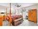 Spacious main bedroom features a decorative four-poster bed, ceiling fan, and natural lighting at 2218 Woodmere Rd, Venice, FL 34293