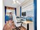 Home office featuring hardwood floors, a large window, and views into the living room at 2218 Woodmere Rd, Venice, FL 34293