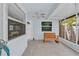 Cozy enclosed patio features tile floors, a ceiling fan, and a wooden rocking bench at 2218 Woodmere Rd, Venice, FL 34293