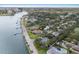 Charming aerial view of waterfront homes, tropical landscaping, and neighborhood pools, offering a glimpse of luxurious community living at 2401 Riverview Blvd, Bradenton, FL 34205
