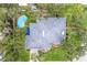 Aerial view of home showcasing the pool, roof, and surrounding greenery at 2401 Riverview Blvd, Bradenton, FL 34205