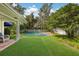 Lush backyard featuring a well-maintained lawn and a sparkling blue pool at 2401 Riverview Blvd, Bradenton, FL 34205