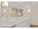 Bathroom featuring double sinks, modern fixtures, large mirror, and a glass-enclosed shower at 2401 Riverview Blvd, Bradenton, FL 34205