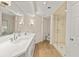 Bathroom with double vanity, walk-in shower with glass door, and neutral color tones at 2401 Riverview Blvd, Bradenton, FL 34205