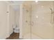 Bright bathroom featuring a glass-enclosed shower and neutral tile at 2401 Riverview Blvd, Bradenton, FL 34205