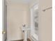 Bathroom featuring a pedestal sink and window that provides natural light at 2401 Riverview Blvd, Bradenton, FL 34205