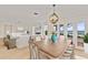 Dining room with views of the water and seamless flow to living area at 2401 Riverview Blvd, Bradenton, FL 34205