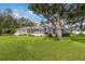 Sprawling single-story home featuring a large, well-maintained lawn and multiple windows at 2401 Riverview Blvd, Bradenton, FL 34205
