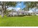 Charming one-story home with lush landscaping and a well-manicured front lawn at 2401 Riverview Blvd, Bradenton, FL 34205