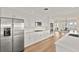 Bright kitchen featuring stainless appliances, white cabinets, hardwood flooring and seating area at 2401 Riverview Blvd, Bradenton, FL 34205