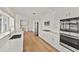 Bright kitchen featuring modern stainless steel appliances, white cabinets, and hardwood flooring at 2401 Riverview Blvd, Bradenton, FL 34205