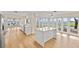 Large, open-concept kitchen with an island, water views, and access to an outdoor patio at 2401 Riverview Blvd, Bradenton, FL 34205
