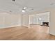 Open living room area with fireplace and scenic lake views from the windows at 2401 Riverview Blvd, Bradenton, FL 34205