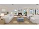 Bright living room showcasing a fireplace, water views, and ample seating at 2401 Riverview Blvd, Bradenton, FL 34205