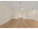Spacious living room features neutral paint, ceiling fan, and open doorway at 2401 Riverview Blvd, Bradenton, FL 34205