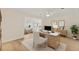 Well-lit office features light wood flooring, a stylish desk, and an open view into an elegant living room at 2401 Riverview Blvd, Bradenton, FL 34205